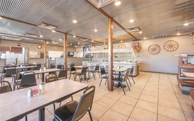 Tiled dining area featuring metal ceiling | Image 7