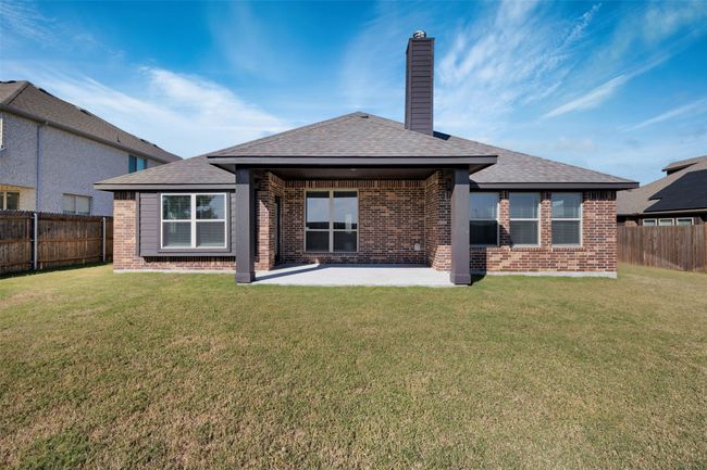 Rear view of property with a covered patio area and a yard | Image 40