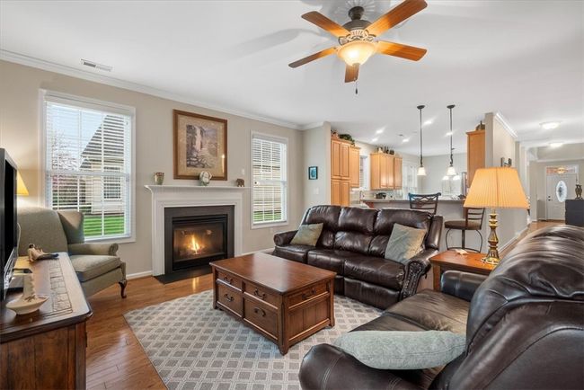 Cozy up to the fireplace on those cold days and grab a book to read. Notice how the kitchen opens to the family room for ease of communication between the 2 rooms. | Image 8