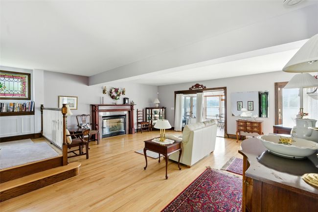 Living room with light wood-style floors and a tile fireplace | Image 23