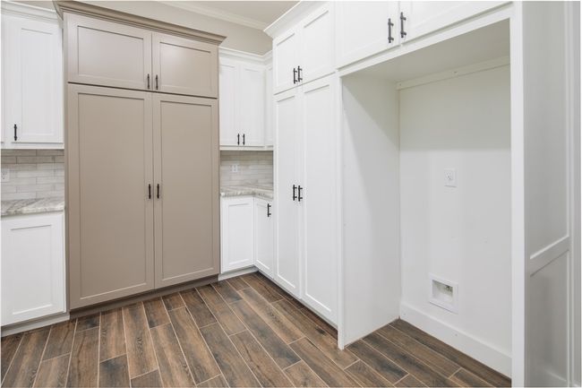 Mudroom featuring dark wood finished floors and crown molding | Image 8