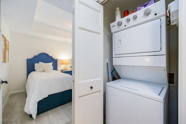 Clothes washing area featuring stacked washer and dryer right in the condo | Image 19