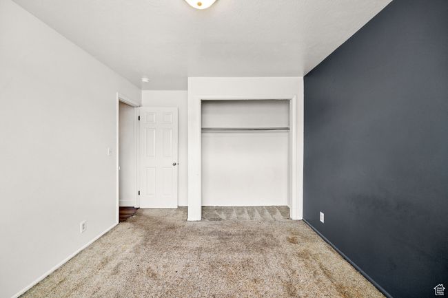 Unfurnished bedroom featuring carpet, a closet, and baseboards | Image 16