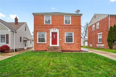 View of front of house with a garage, a front lawn, and an outdoor structure | Image 1