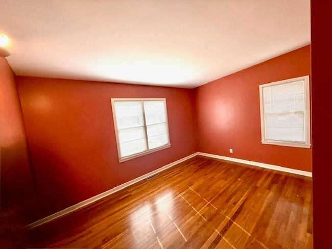 Empty room featuring baseboards, visible vents, and wood finished floors | Image 14