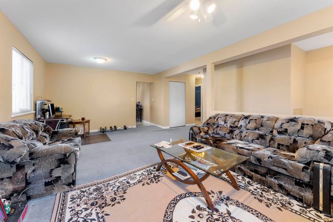 Living room featuring carpet, baseboards, and a ceiling fan | Image 7