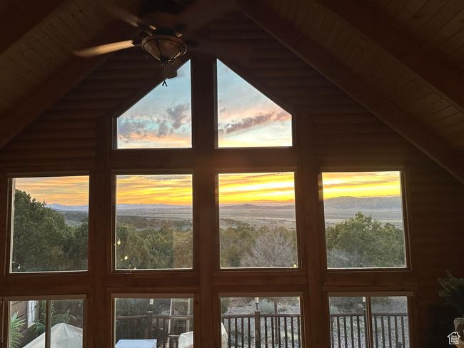Room details with a mountain view, wooden ceiling, a ceiling fan, and beam ceiling | Image 10