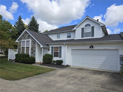 Front of townhouse featuring stone and vinly siding | Image 1