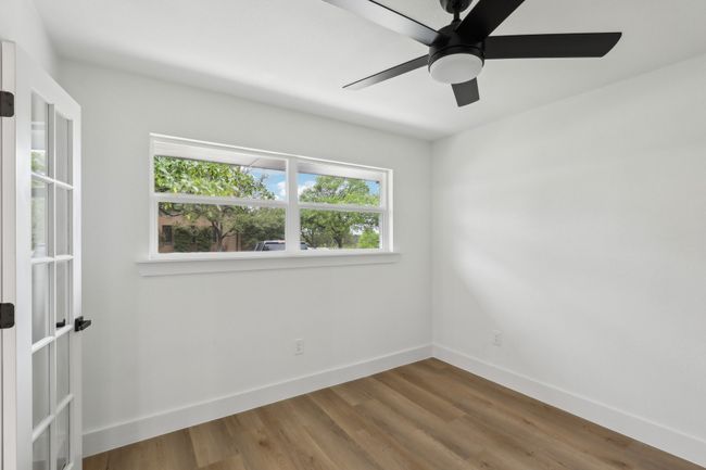 Office room featuring baseboards, wood finished floors, and a ceiling fan | Image 10