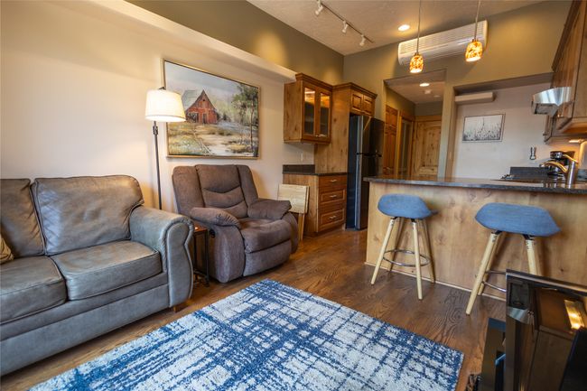 Living area with track lighting and dark wood-type flooring | Image 6