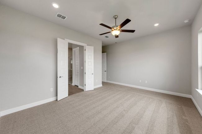 Unfurnished bedroom with carpet flooring, recessed lighting, and a ceiling fan | Image 11
