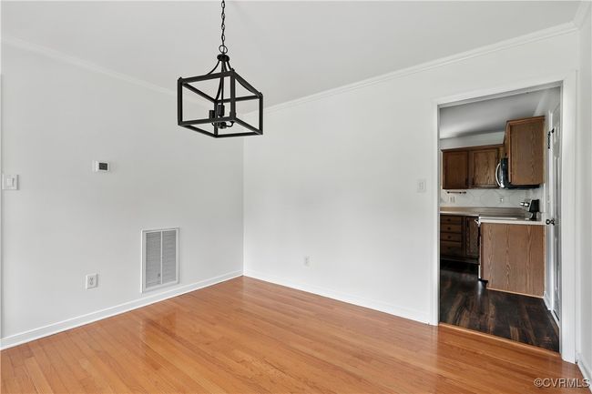 Another View dining Room with a chandelier, light wood-style flooring, and ornamental molding | Image 13