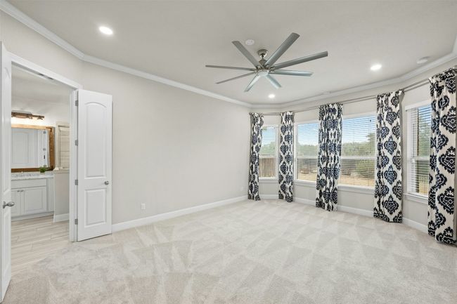 The private owner's retreat offers a spacious bedroom with large windows that fill the space with natural light. | Image 17