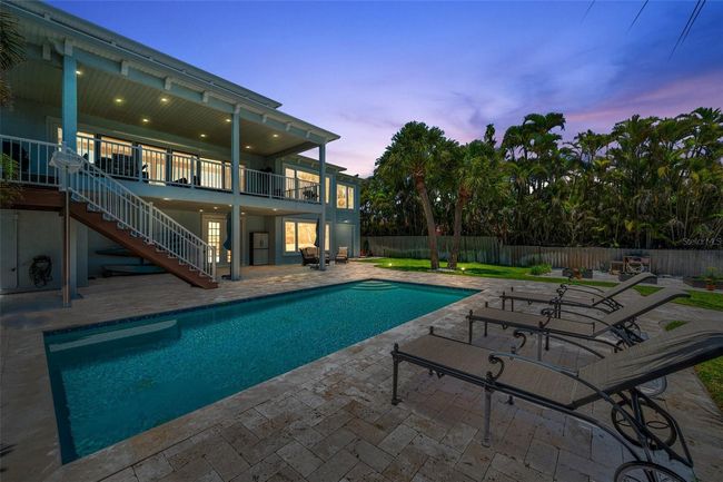Twilight view of the pool, lanai and balcony. | Image 7