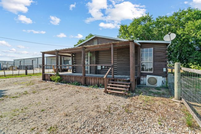 View of front of home featuring ac unit, log siding, and covered porch | Image 9