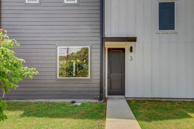 Entrance to property featuring a lawn and board and batten siding | Image 28
