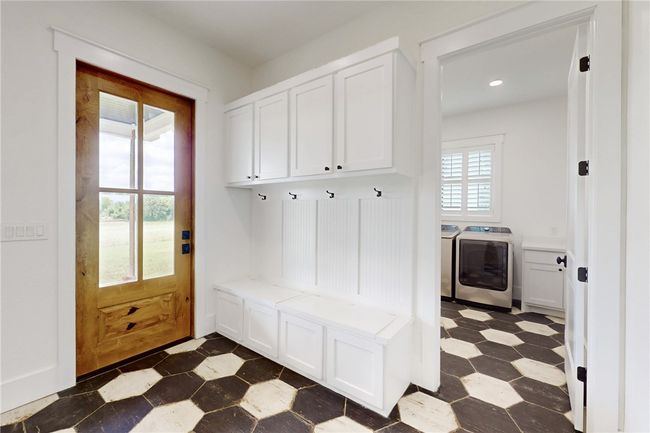 Mudroom featuring washing machine and clothes dryer, dark floors, and recessed lighting | Image 14