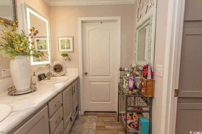 Bathroom featuring ornamental molding, double vanity, and a sink | Image 30