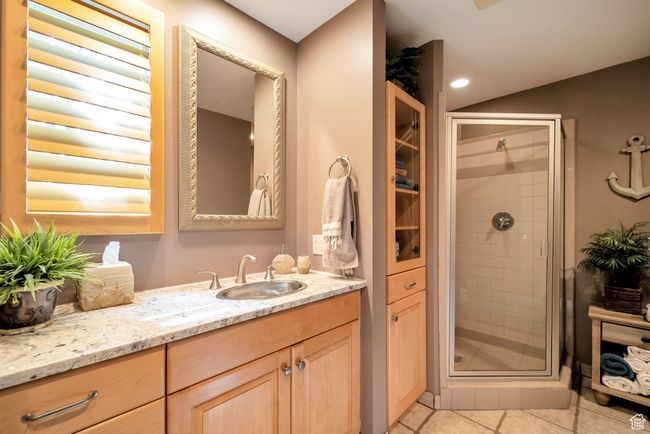 Bathroom featuring tile patterned floors, vanity, and a shower stall | Image 19