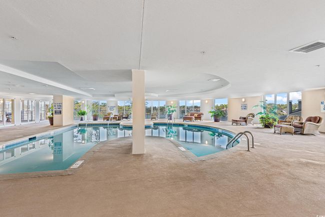 Indoor pool featuring a patio area | Image 31