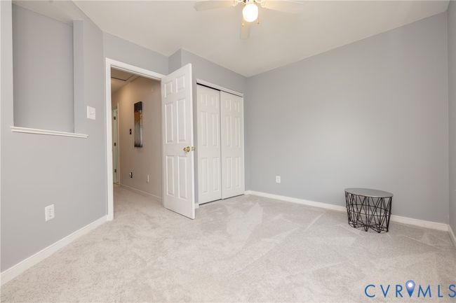 Unfurnished bedroom with carpet flooring, a closet, and a ceiling fan | Image 32