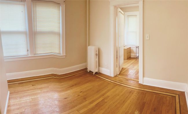 Spare room with radiator and light wood-style floors | Image 9
