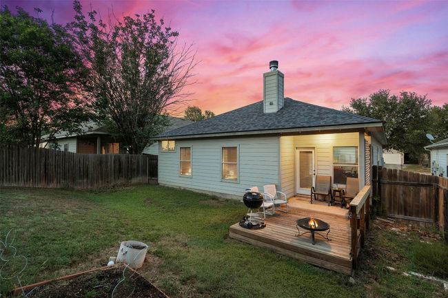 Relax on the covered back patio or deck offering the perfect spot to watch the sunset in your private, fenced in yard. | Image 37