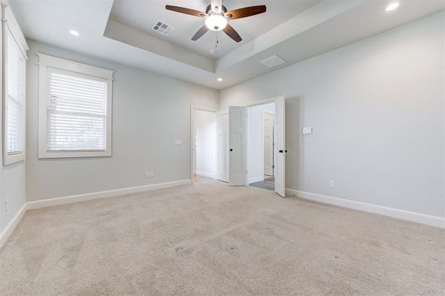 Large primary suite with tray ceiling and plenty of light. | Image 14