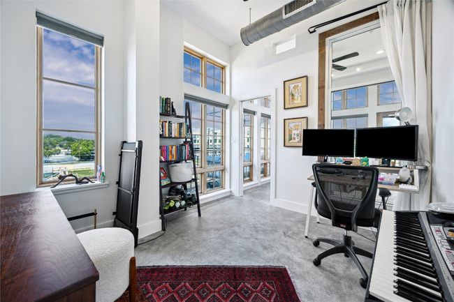 Office space with french doors, finished concrete flooring, and ceiling fan | Image 18