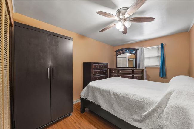 Bedroom with wood finished floors and ceiling fan | Image 33