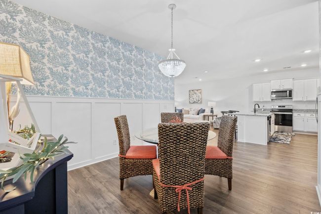 Dining area with a wainscoted wall, wallpapered walls, and wood finished floors | Image 13