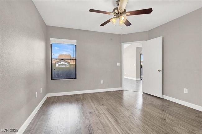 Unfurnished room featuring wood finished floors, a ceiling fan, and baseboards | Image 18