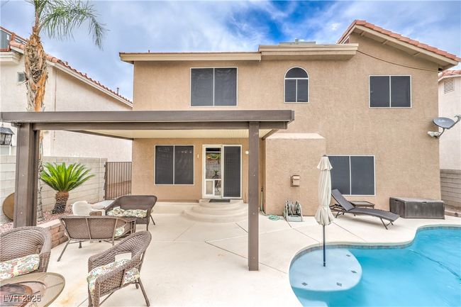 Back of house with stucco siding, a patio, an outdoor hangout area, and entry steps | Image 34