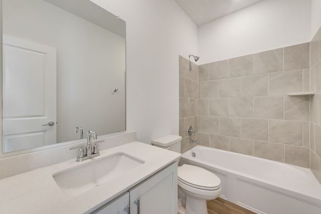 Bathroom with vanity, tub / shower combination, and wood finished floors | Image 16