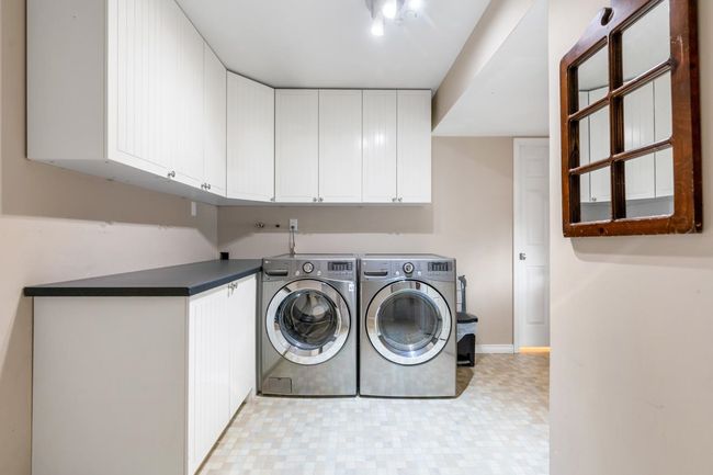 Laundry room with baseboards, cabinet space, light floors, and independent washer and dryer | Image 25