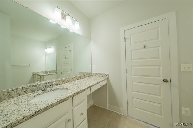 Bathroom featuring vanity, tile patterned floors, and baseboards | Image 38