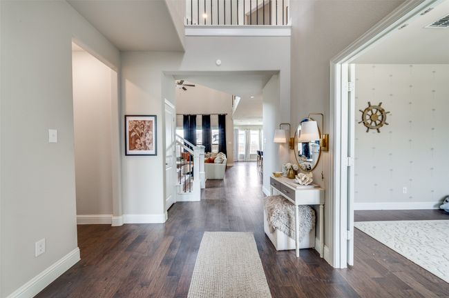 Entrance foyer with visible vents, baseboards, a ceiling fan, and dark wood finished floors | Image 5
