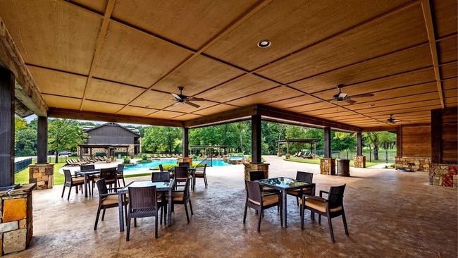 View of patio / terrace with a ceiling fan, outdoor dining area, an outdoor pool, and an outbuilding | Image 21