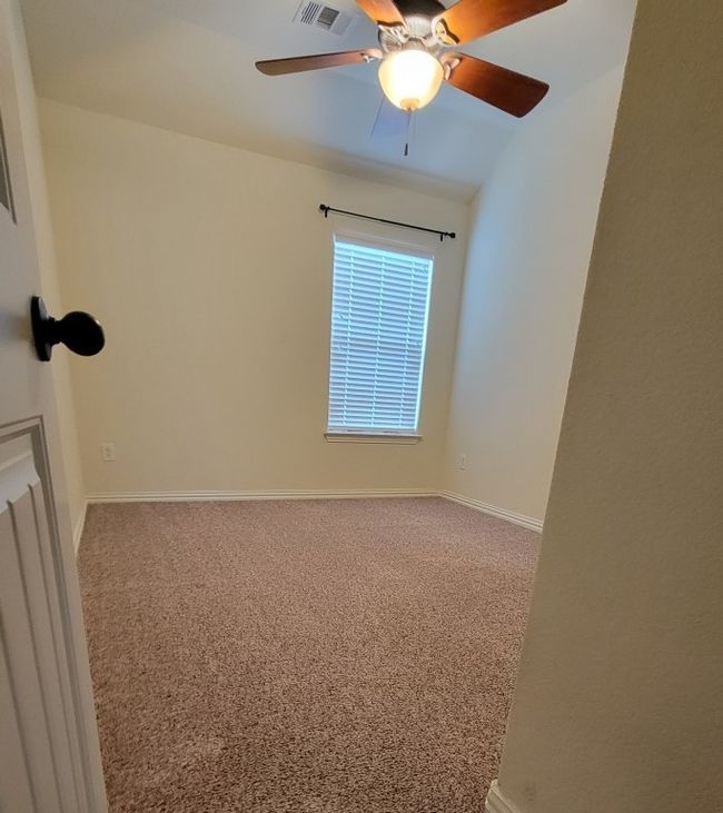 Spare room with carpet flooring, baseboards, and a ceiling fan | Image 18