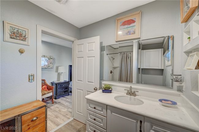 Full bathroom featuring wood finished floors, a shower with curtain, and vanity | Image 36