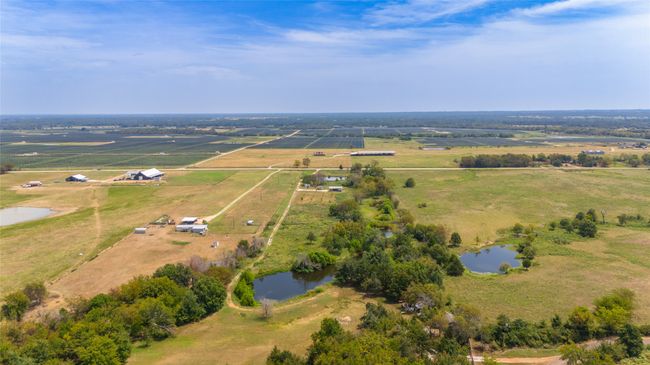 View from the back of the property. Back property line follows the road behind the pond....approximately. | Image 19