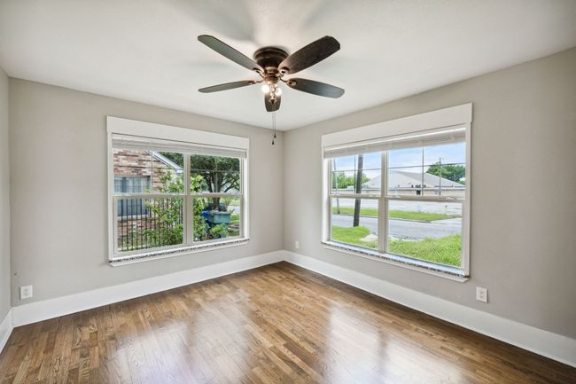 Spare room featuring wood finished floors, plenty of natural light, and a ceiling fan | Image 13