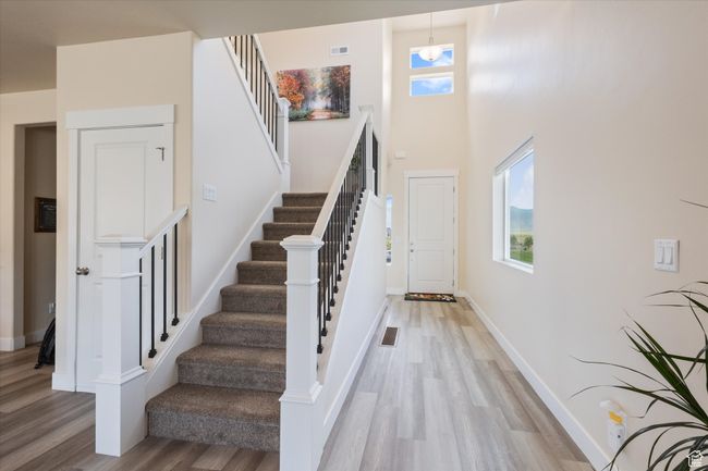Stairway featuring wood finished floors and a high ceiling | Image 15