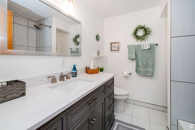 Bathroom featuring vanity, toilet, and tile patterned floors | Image 26