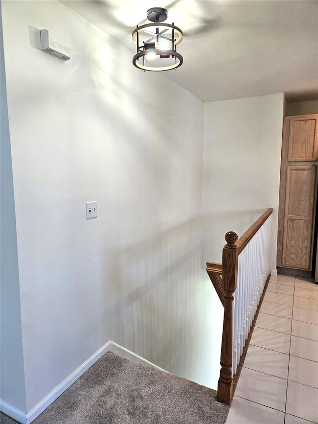 A Sun Filled Stairway With Beautiful Oak Bannisters & Railings Leads To The Cabinet Lined Kitchen Offering Loooots Of Storage Cabinetry/Storage Space, Ample Counter/Serving Space & A Barstool Area, All New Frigidaire Stainless Steel Appliances, Recessed Lighting, Ceramic Tile Floors & Two Large Windows For Natural Light. | Image 4