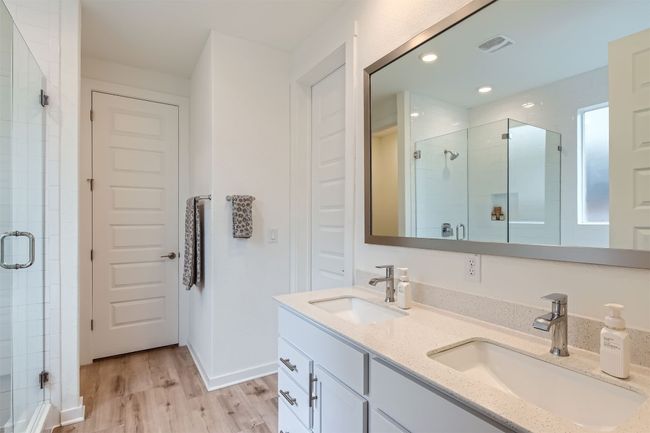 Bathroom featuring double sinks and a stall shower | Image 15