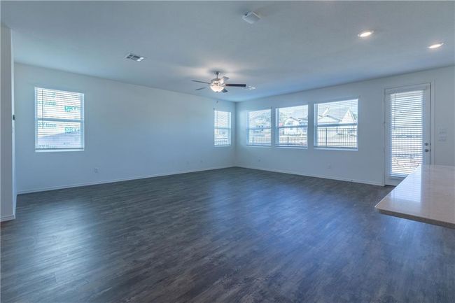 Spare room featuring dark wood-style floors, plenty of natural light, ceiling fan, and recessed lighting | Image 18