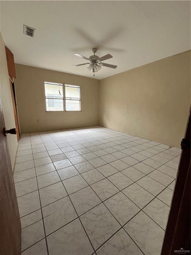 Unfurnished room with ceiling fan and light tile patterned flooring | Image 4