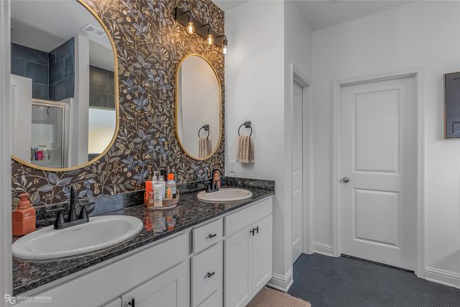 Bathroom with double vanity, visible vents, an enclosed shower, and a sink | Image 15