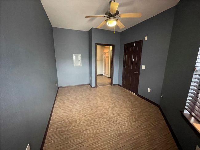 Spare room featuring wood finished floors, ceiling fan, and baseboards | Image 16